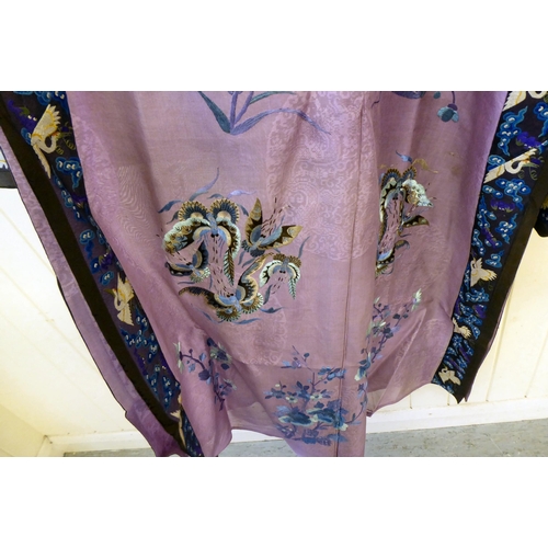 241 - A Chinese purple fabric robe dress, embroidered with flowers, birds and butterflies