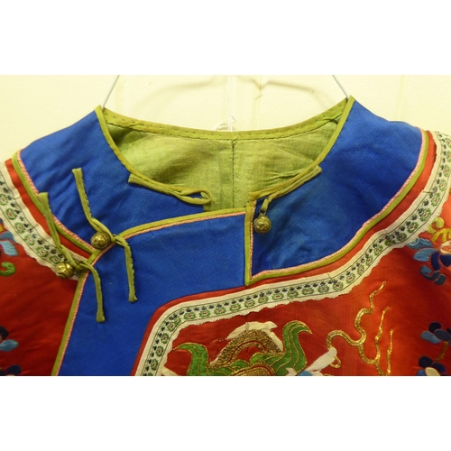 247 - A Chinese red fabric jacket, embroidered with dragons