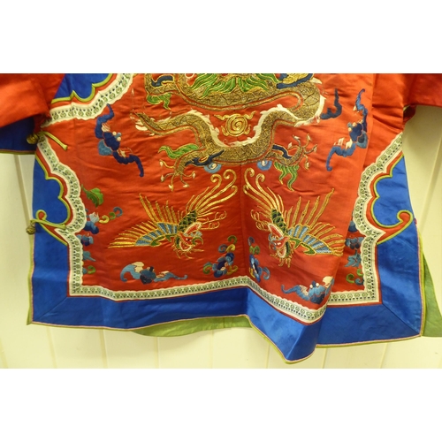 247 - A Chinese red fabric jacket, embroidered with dragons