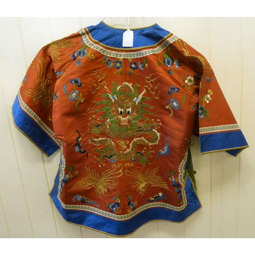 247 - A Chinese red fabric jacket, embroidered with dragons