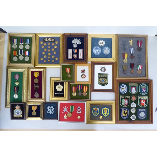 254 - Framed replica medals, awards and buttons: to include World War II examples  largest 14.5