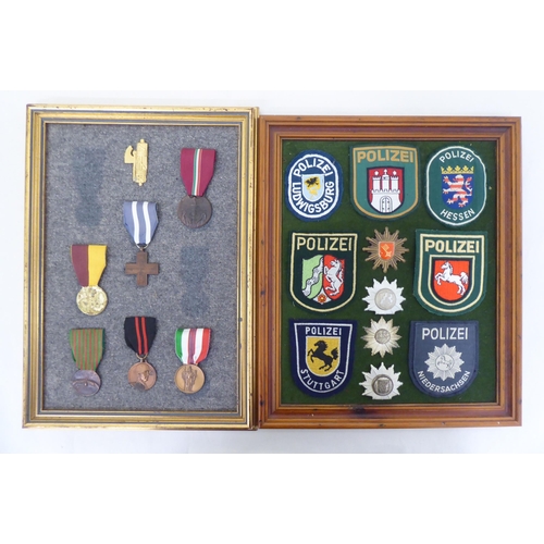 254 - Framed replica medals, awards and buttons: to include World War II examples  largest 14.5