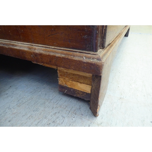 255 - An early 19thC oak mule chest, raised on bracket feet  34