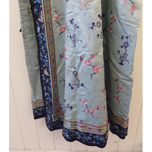 257 - A Chinese mint green fabric robe dress, embroidered with prunus blossom and butterflies