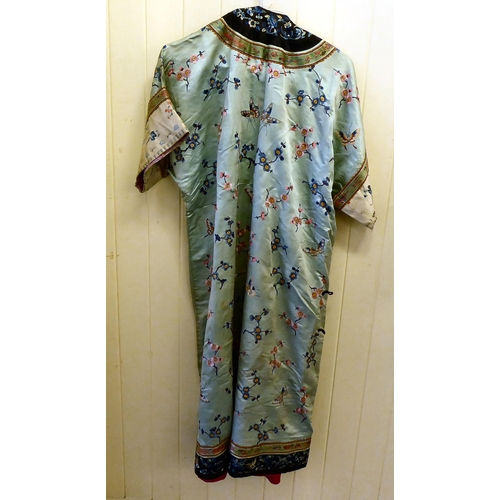 257 - A Chinese mint green fabric robe dress, embroidered with prunus blossom and butterflies