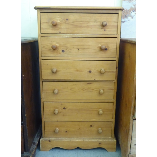 258 - A modern pine tall boy, comprising six drawers with bun  handles, on a plinth  42