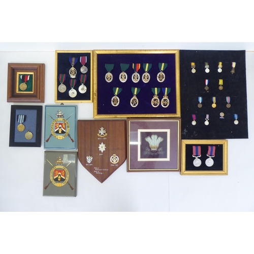 259 - Framed replica medals and awards: to include mid 20thC examples  largest 15