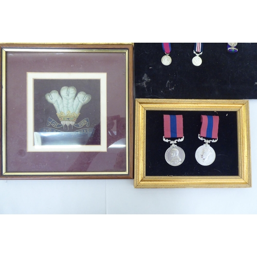 259 - Framed replica medals and awards: to include mid 20thC examples  largest 15