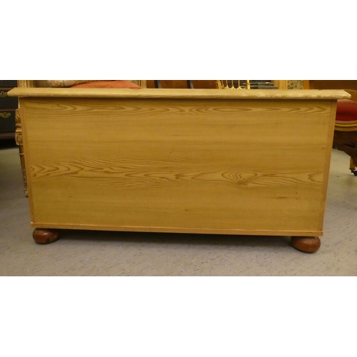 260 - A modern pine blanket chest, raised on bun feet  19.5