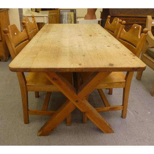 271 - A modern pine, farmhouse style dining table, raised on crossed legs, united by a stretcher  27.... 