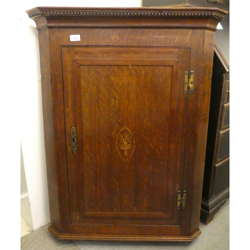 272 - A mid 19thC oak hanging corner cabinet, the hinged door inlaid with a flowering vase design, enclosi... 