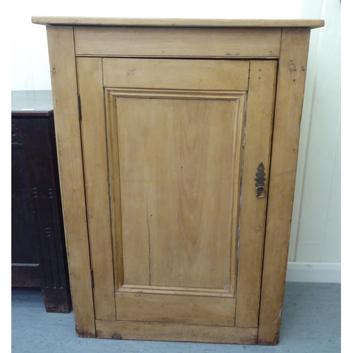 275 - A modern pine cupboard, the planked top over a single door, enclosing three shelves, on a solid base... 