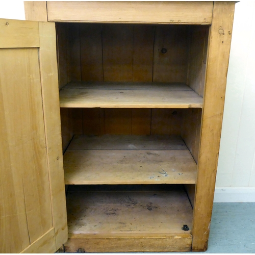 275 - A modern pine cupboard, the planked top over a single door, enclosing three shelves, on a solid base... 