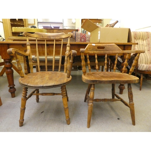 281 - An early 20thC beech framed captain's chair, the tapered bar back over a circular seat, raised on tu... 