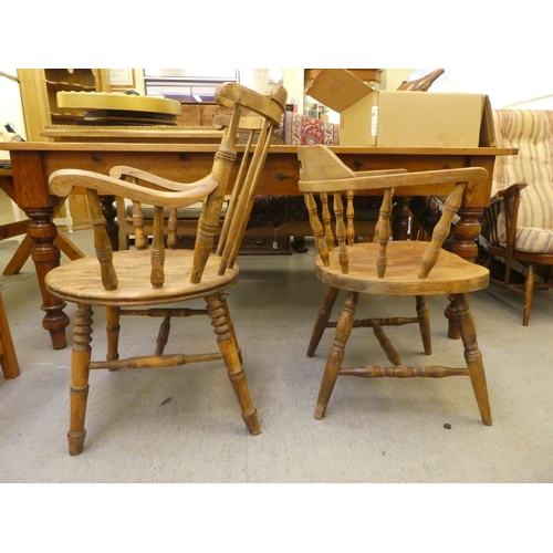 281 - An early 20thC beech framed captain's chair, the tapered bar back over a circular seat, raised on tu... 