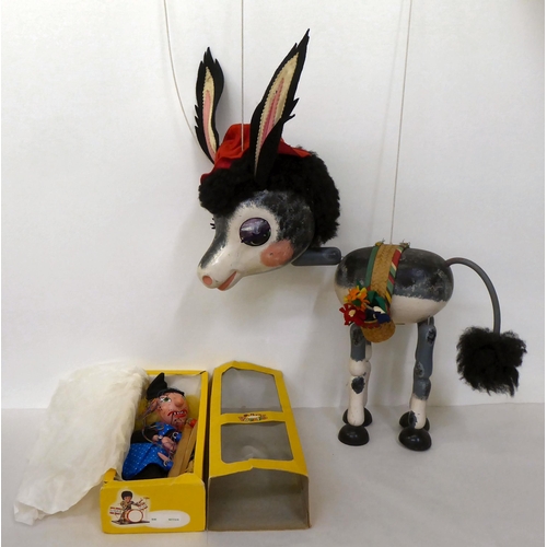 285 - A Pelham oversize shop display puppet, a female donkey; and another standard puppet, a witch