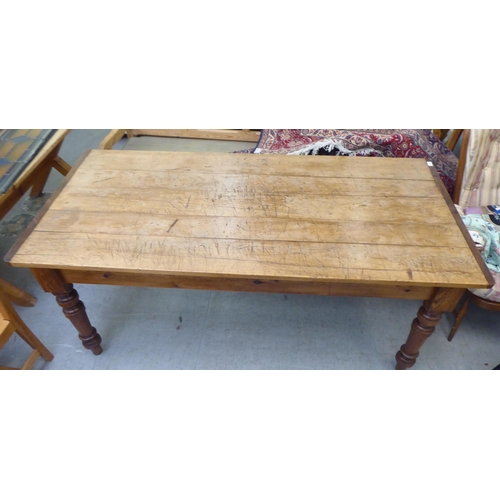 292 - A modern pine farmhouse dining table with a plank constructed top, raised on turned, tapered legs&nb... 