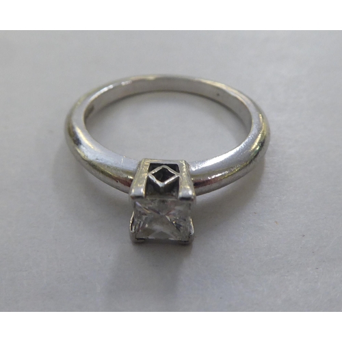 295 - A platinum solitaire ring, set with a princess cut diamond