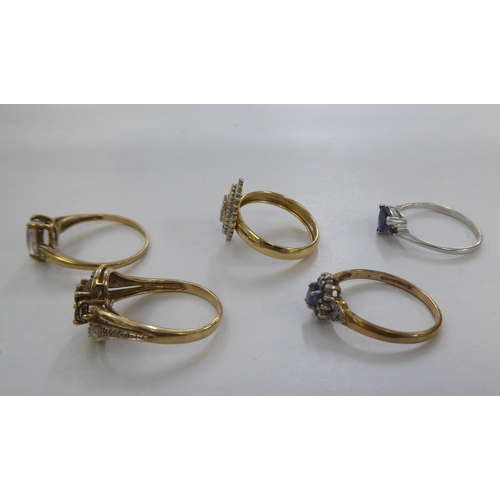 300 - Five 9ct gold dress rings: to include a cluster ring, set with a central blue stone, surrounded by d... 