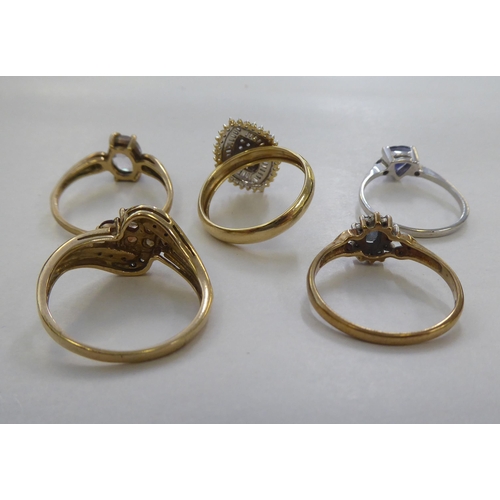 300 - Five 9ct gold dress rings: to include a cluster ring, set with a central blue stone, surrounded by d... 