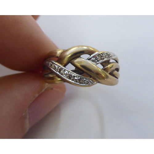 305 - A 9ct gold ring of woven design, set with diamonds