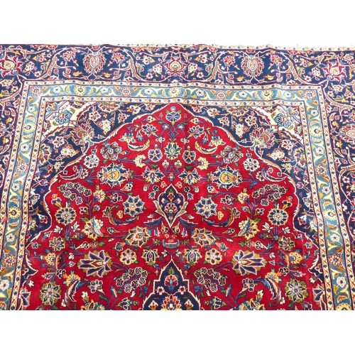 307 - An Iranian carpet, profusely decorated with repeating stylised designs, on a multi-coloured ground  ... 