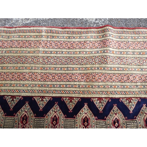 309 - A Bokhara carpet, on a mainly cream coloured ground  88