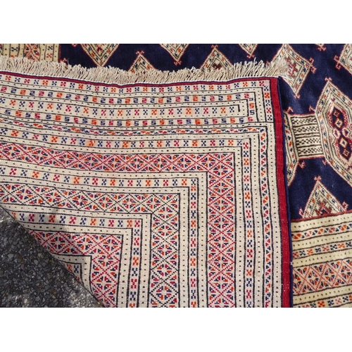 309 - A Bokhara carpet, on a mainly cream coloured ground  88