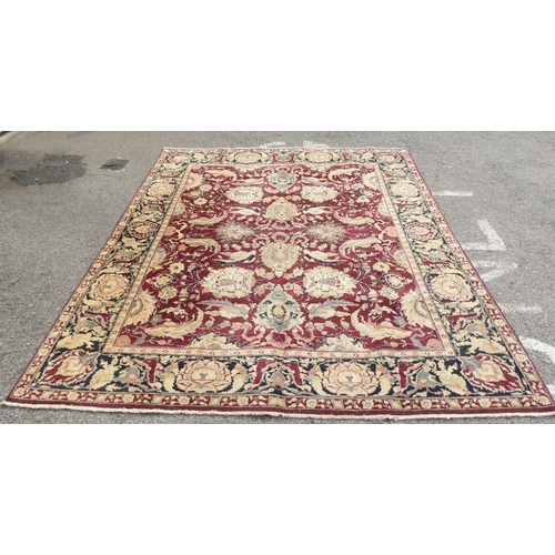 315 - A Persian rug with floral motifs, on a brown and green ground  115