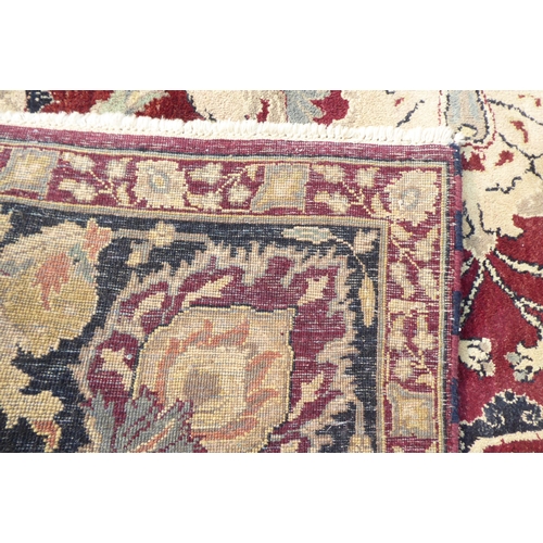 315 - A Persian rug with floral motifs, on a brown and green ground  115