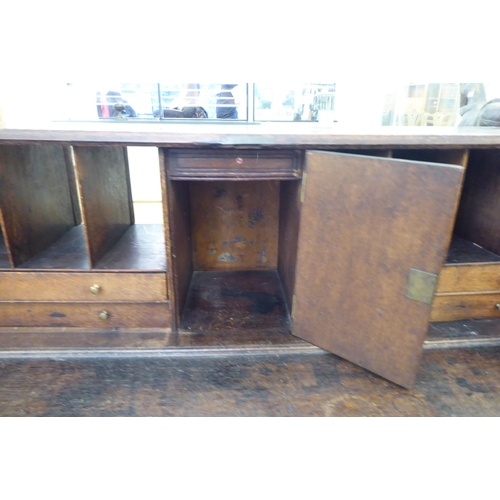 316 - An early 20thC carved oak bureau, the fall front over four long drawers, on a plinth  40.5