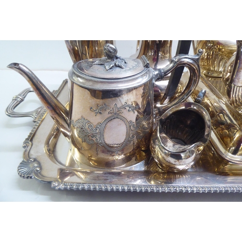 39 - Silver plate: to include a serving tray with a cast border and opposing handles  25