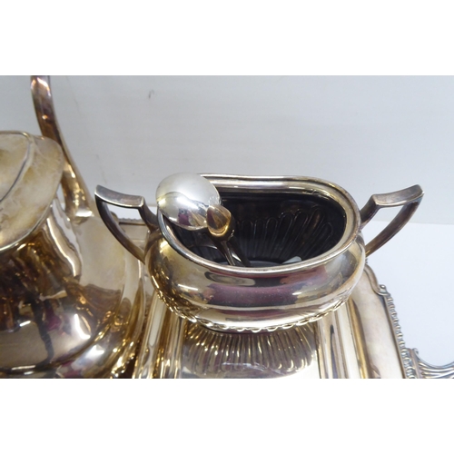 39 - Silver plate: to include a serving tray with a cast border and opposing handles  25