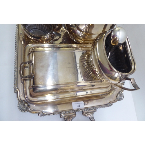 39 - Silver plate: to include a serving tray with a cast border and opposing handles  25