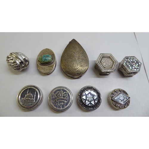 40 - Silver and white metal pill boxes: to include an example fashioned as a walnut