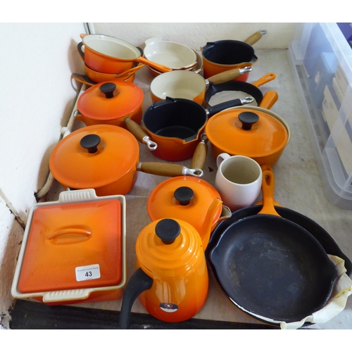 43 - Le Creuset cast iron and similar cookware, mainly in orange finish