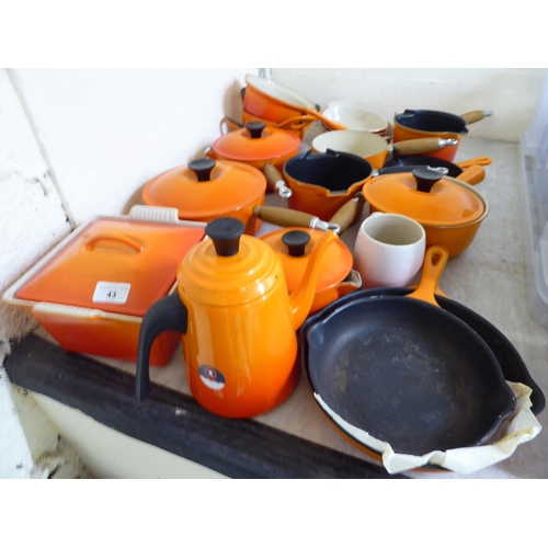 43 - Le Creuset cast iron and similar cookware, mainly in orange finish