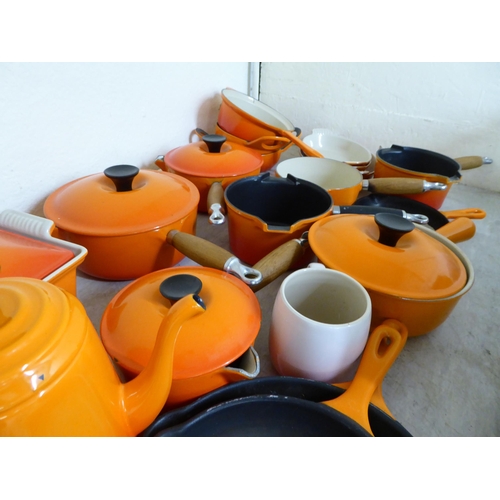 43 - Le Creuset cast iron and similar cookware, mainly in orange finish