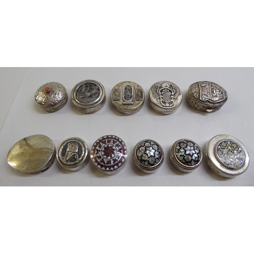 49 - Silver and white metal pill boxes: to include an Egyptian example, decorated with mother-of-pearl