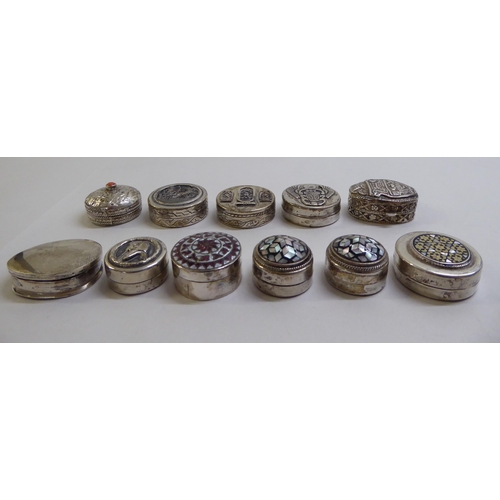 49 - Silver and white metal pill boxes: to include an Egyptian example, decorated with mother-of-pearl