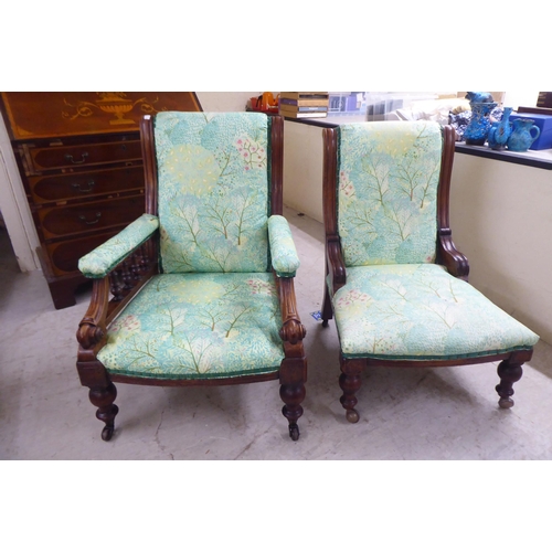 5 - Two matched Edwardian mahogany showwood framed salon chairs, later stud upholstered in floral patter... 