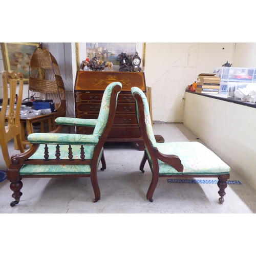 5 - Two matched Edwardian mahogany showwood framed salon chairs, later stud upholstered in floral patter... 