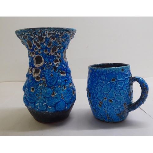 63 - Five items of blue/black Lava pottery: to include a vase  8