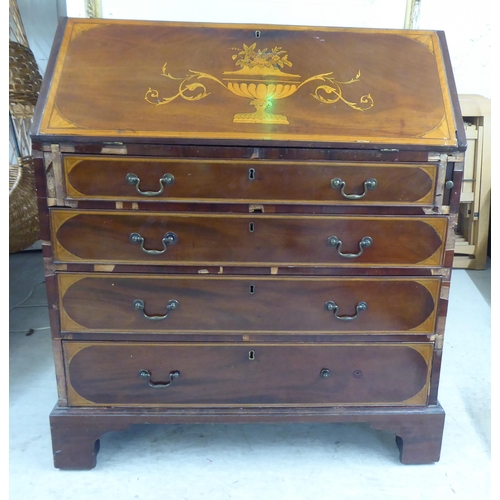 98 - An Edwardian string inlaid marquetry bureau, the fall flap over four graduated drawers, raised on br... 