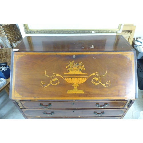 98 - An Edwardian string inlaid marquetry bureau, the fall flap over four graduated drawers, raised on br... 