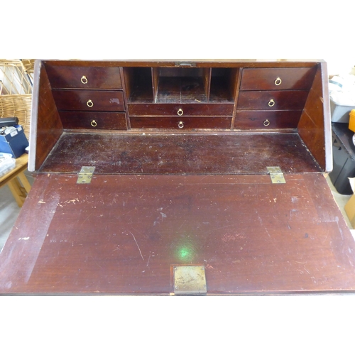 98 - An Edwardian string inlaid marquetry bureau, the fall flap over four graduated drawers, raised on br... 