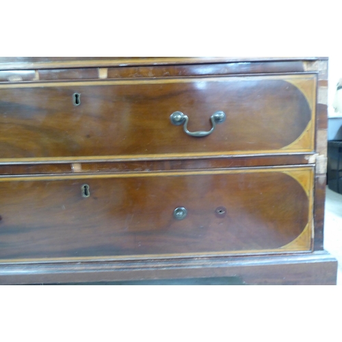 98 - An Edwardian string inlaid marquetry bureau, the fall flap over four graduated drawers, raised on br... 