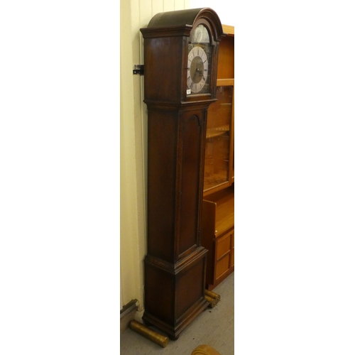 113 - A mid 20thC oak cased longcase clock; the three tone setting movement faced by a brushed steel and b... 