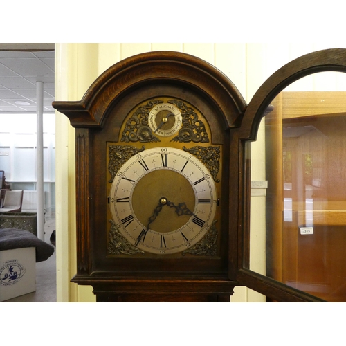 113 - A mid 20thC oak cased longcase clock; the three tone setting movement faced by a brushed steel and b... 