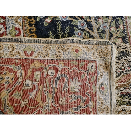 226 - An early 20thC Persian rug, decorated with a central tree of life motif, surrounded by wild animals ... 